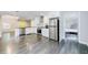Modern kitchen features stainless steel appliances, white cabinets and a yellow door in an open floor plan at 106 Adair Ave, Atlanta, GA 30315