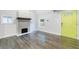 Bright living room featuring elegant fireplace, hardwood floors, and a bright yellow door at 106 Adair Ave, Atlanta, GA 30315