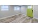 This bright living room features new flooring, fresh paint, and natural light from two large windows at 106 Adair Ave, Atlanta, GA 30315
