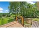 Relaxing back deck overlooks a spacious fenced backyard with mature trees and lush greenery at 1400 Land Rd, Canton, GA 30114