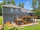 Back exterior view of a two-story home with a multi-level deck, stairs, and outdoor seating at 1400 Land Rd, Canton, GA 30114