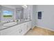 Bright bathroom with double sinks, updated countertops, and a large mirror at 1400 Land Rd, Canton, GA 30114