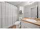 Functional bathroom with a shower-tub combo, neutral walls, and ample vanity space at 1400 Land Rd, Canton, GA 30114
