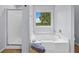 Relaxing bathroom featuring a soaking tub, separate shower, and natural light from the window at 1400 Land Rd, Canton, GA 30114