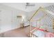 Bright bedroom with a patterned accent wall, featuring a playful house-frame bed, and a ceiling fan at 1400 Land Rd, Canton, GA 30114
