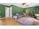 Spacious living room boasts hardwood floors, a ceiling fan, and comfortable seating at 1400 Land Rd, Canton, GA 30114
