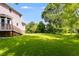 Expansive backyard with lush green grass and mature trees, perfect for outdoor activities at 3348 Summit Turf Ln, Snellville, GA 30078