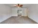 An open bedroom with a ceiling fan, neutral carpet, and a view into the attached bathroom at 3348 Summit Turf Ln, Snellville, GA 30078