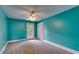 Bedroom with a ceiling fan, door to the outside, a closet, and brightly painted blue walls at 3348 Summit Turf Ln, Snellville, GA 30078