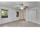 A carpeted bedroom featuring two windows, double closet doors and white walls at 3348 Summit Turf Ln, Snellville, GA 30078