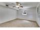 Spacious carpeted bedroom featuring a ceiling fan, white walls and a window providing natural light at 3348 Summit Turf Ln, Snellville, GA 30078