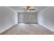 A bedroom with neutral carpet, a ceiling fan, and a glass paneled door to the outside at 3348 Summit Turf Ln, Snellville, GA 30078