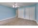 A bright bedroom with blue walls, a ceiling fan and two large closets with paneled doors at 3348 Summit Turf Ln, Snellville, GA 30078