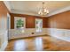 Dining room featuring hardwood floors, wainscoting, and a chandelier at 3348 Summit Turf Ln, Snellville, GA 30078