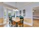 Dining room with bay windows to the backyard, adjacent to a hallway with hardwood floors at 3348 Summit Turf Ln, Snellville, GA 30078