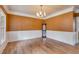 Dining room with hardwood floors, wainscoting, and view of a decorative china cabinet at 3348 Summit Turf Ln, Snellville, GA 30078