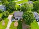 Overhead view of a charming house with a manicured lawn, mature trees, and a long driveway at 3348 Summit Turf Ln, Snellville, GA 30078