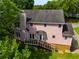 Aerial shot of backyard featuring the deck and backyard with lush lawn and mature trees at 3348 Summit Turf Ln, Snellville, GA 30078