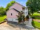 Charming pink two-story home with a two-car garage and a second-story porch at 3348 Summit Turf Ln, Snellville, GA 30078