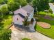 Aerial view of a pink two-story home with a two-car garage and a neatly landscaped yard at 3348 Summit Turf Ln, Snellville, GA 30078