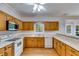 Kitchen boasts oak cabinets, white countertops, a view of the outdoors, and stainless steel appliances at 3348 Summit Turf Ln, Snellville, GA 30078