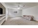 Carpeted living room featuring a ceiling fan, large window and a couch at 3348 Summit Turf Ln, Snellville, GA 30078