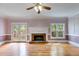 Light-filled living room featuring hardwood floors, fireplace, and access to the backyard at 3348 Summit Turf Ln, Snellville, GA 30078