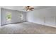 Bright living room with carpet, ceiling fan, and access to the outdoors through a glass door at 3348 Summit Turf Ln, Snellville, GA 30078