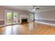 Spacious living room with hardwood floors, fireplace, and french doors leading to the backyard at 3348 Summit Turf Ln, Snellville, GA 30078