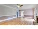 Open living room featuring hardwood floors, crown molding, and a cozy brick fireplace at 3348 Summit Turf Ln, Snellville, GA 30078