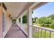 A covered porch with white railing offers a view of the front yard and neighborhood at 3348 Summit Turf Ln, Snellville, GA 30078