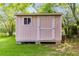Charming backyard shed with a window and door, providing extra storage space at 3348 Summit Turf Ln, Snellville, GA 30078