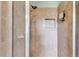 Walk-in tiled shower featuring a rainfall shower head and built-in niche with a soap holder at 3348 Summit Turf Ln, Snellville, GA 30078