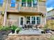 Outdoor patio area with a dining table surrounded by green landscaping at 3534 Clancy Way, Smyrna, GA 30080