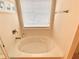 Bright soaking tub with window and clean neutral finishes at 3534 Clancy Way, Smyrna, GA 30080