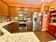 Modern kitchen featuring stainless steel appliances, granite countertops, and warm wood cabinets at 3534 Clancy Way, Smyrna, GA 30080