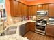 Well-lit kitchen featuring stainless steel appliances, wooden cabinets, and stone countertops at 3534 Clancy Way, Smyrna, GA 30080