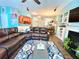 Spacious living room featuring a leather sectional sofa, a blue and white rug, and an open-concept design at 3534 Clancy Way, Smyrna, GA 30080