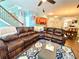 Comfortable living room showcasing a large leather sectional, stylish rug, and seamless flow into the dining area at 3534 Clancy Way, Smyrna, GA 30080
