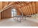 Spacious attic with exposed rafters, a ping pong table, and a window at 4042 Laurel Bend Ct, Snellville, GA 30039