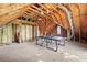 Spacious unfinished attic with exposed wood rafters, a ping pong table, and a window at 4042 Laurel Bend Ct, Snellville, GA 30039