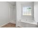 Bathroom featuring a soaking tub under a window and separate shower at 4042 Laurel Bend Ct, Snellville, GA 30039