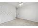 A bright, carpeted bedroom featuring a ceiling fan, two closets and a doorway at 4042 Laurel Bend Ct, Snellville, GA 30039