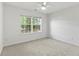 Neutral bedroom featuring carpet, a ceiling fan, and a large window at 4042 Laurel Bend Ct, Snellville, GA 30039