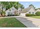 Charming traditional home with manicured lawn, stone accents, and attached two-car garage at 4042 Laurel Bend Ct, Snellville, GA 30039