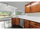Eat-in kitchen with wooden cabinets, stainless steel appliances, and large window at 4042 Laurel Bend Ct, Snellville, GA 30039