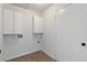 Clean laundry room with white cabinets and hookups at 4042 Laurel Bend Ct, Snellville, GA 30039