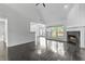 Open concept living area with hardwood floors, vaulted ceilings, fireplace, and large windows at 4042 Laurel Bend Ct, Snellville, GA 30039
