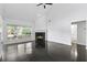 Bright living room featuring a fireplace, ceiling fan, and large windows for ample natural light at 4042 Laurel Bend Ct, Snellville, GA 30039
