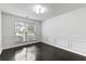 Room featuring chair rail molding, window, and dark wood floors at 4042 Laurel Bend Ct, Snellville, GA 30039